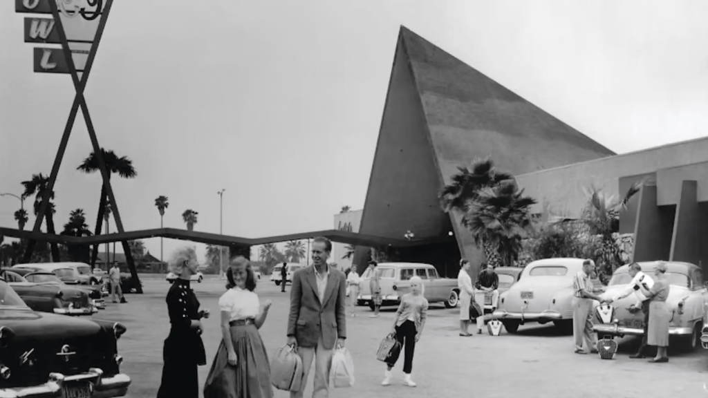 BOWLARAMA: The Architecture of Mid-Century Bowling presented by Chris Nichols Black and white photo of people standing in the front parking lot of a bowling alley